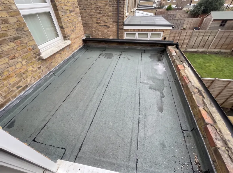 The same flat roof finished in a grey mineral cap sheet